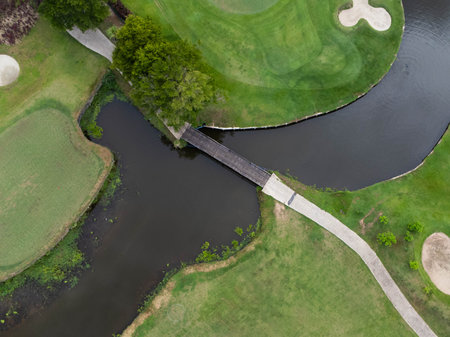 Aerial view of golf course with a rich green turf beautiful scenery. Sand bunkers at a beautiful golf course by the pond.の写真素材