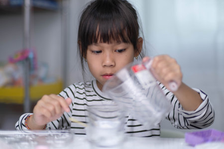 Cute little girl making DIY plaster and painting at home. Children paint on plaster sculptures with family on holiday. Imagination and creativity activities.の写真素材