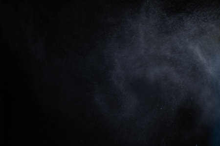 Water spray dust on dark background. Spraying mist effect isolated on black background.の写真素材