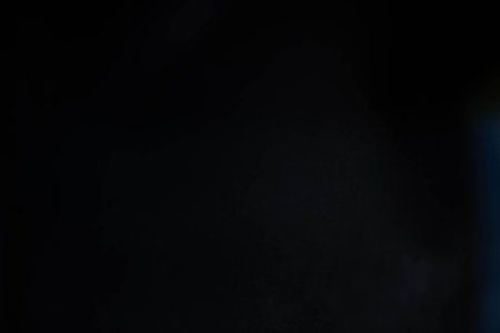 Water spray dust on dark background. Spraying mist effect isolated on black background.の写真素材
