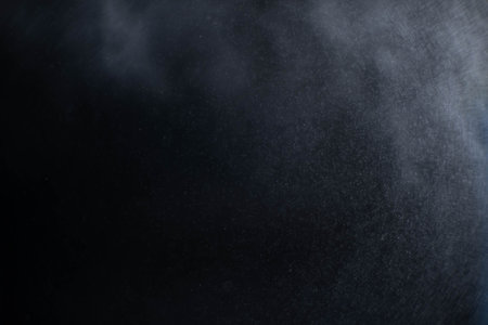 Water spray dust on dark background. Spraying mist effect isolated on black background.の写真素材