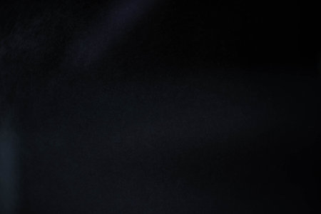 Water spray dust on dark background. Spraying mist effect isolated on black background.の写真素材