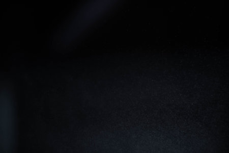Water spray dust on dark background. Spraying mist effect isolated on black background.の写真素材