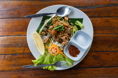 Stir-fried rice noodles with black soy sauce, pork and kale. Thai food (Pad See Ew)の写真素材