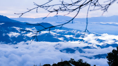 Aerial view over the mountains with sea of fog during morning sunrise in blue sky. Sea of clouds around mountain peaks at sunrise. Unseen travel in Northern Thailand.の写真素材