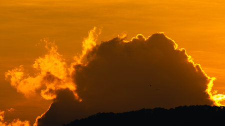 Closeup of bright big sun on the sky with orange gradient colors in a calmly evening.の写真素材