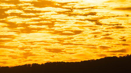 Time lapse of the beautiful sky with clouds at sunset. Sunset sky at dusk in the evening with natural sky background with golden orange clouds.の写真素材