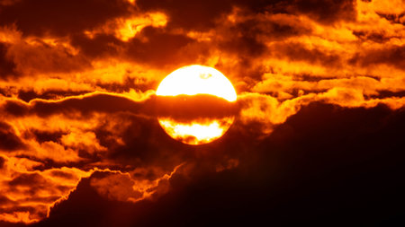 Time lapse of the beautiful sky with clouds at sunset. Sunset sky at dusk in the evening with natural sky background with golden orange clouds.の写真素材