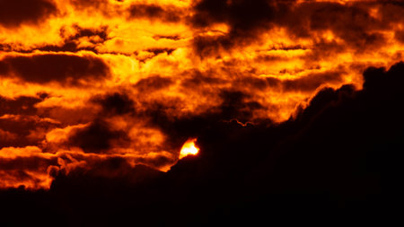 Time lapse of the beautiful sky with clouds at sunset. Sunset sky at dusk in the evening with natural sky background with golden orange clouds.の写真素材