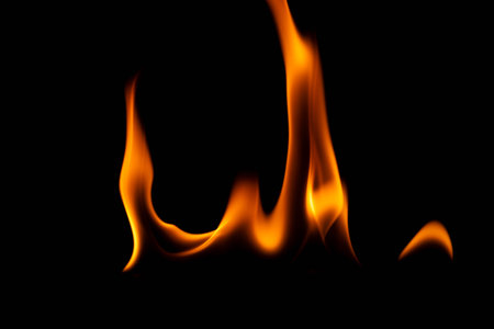 Hot flames on a black background. Beautiful flame of fire in the dark. Abstract of burning flames and smoke.の写真素材