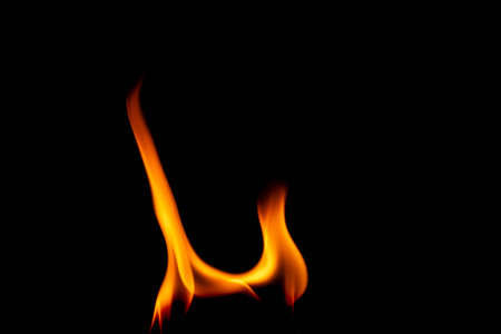 Hot flames on a black background. Beautiful flame of fire in the dark. Abstract of burning flames and smoke.の写真素材