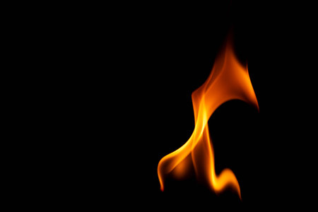 Hot flames on a black background. Beautiful flame of fire in the dark. Abstract of burning flames and smoke.の写真素材
