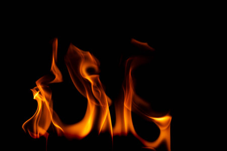 Hot flames on a black background. Beautiful flame of fire in the dark. Abstract of burning flames and smoke.の写真素材