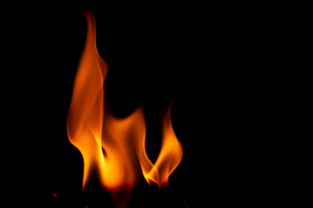 Hot flames on a black background. Beautiful flame of fire in the dark. Abstract of burning flames and smoke.の写真素材