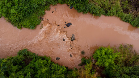Close-up aerial view of the mighty Mekong River shows its muddy waterways flowing hard and fast during the rainy season.の写真素材