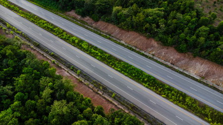 Aerial view of countryside asphalt road with car and green forest. Drive on the road between green forests.の写真素材