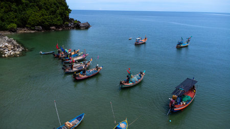 Aerial drone view of traditional colorful thai old wooden fishing boats on shore during low tide. Traditional Thai long-tailed fishing boats in tropical seaの写真素材