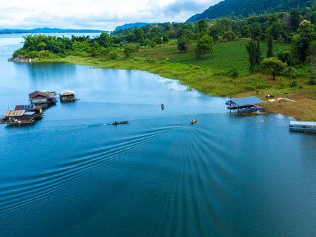 Aerial view of the River Kwai and floating houses in Kanchanaburi Province, Thailand. Beautiful view of floating cottages and Thai long-tail boats sailing on the River Kwai.の写真素材