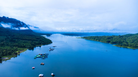 Aerial view of the River Kwai and floating houses in Kanchanaburi Province, Thailand. Beautiful view of floating cottages and Thai long-tail boats sailing on the River Kwai.の写真素材