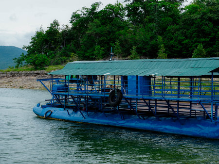 Local ferry transporting cars, motorcycles and people across a river in Kanchanaburi Province,...