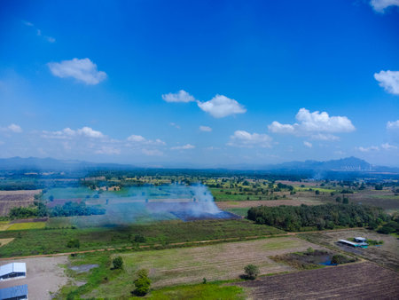 Aerial view of farmers burning corn residue after harvest. Corn field fire after harvest.の写真素材