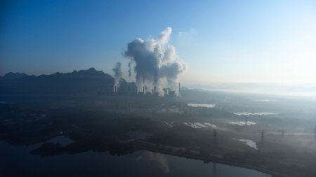 Aerial view of a coal-fired power plant with steam flowing out of the stack in the morning. Mae Moh Power Plant, Lampang, Thailand.の写真素材