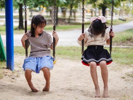 Two little siblings had a fight in the park. Children are upset and fighting in the playground.の写真素材
