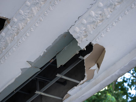 Ceiling panels damaged a large hole in the roof from rainwater leakage. Service and repair concept.