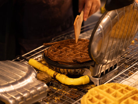 Fresh waffles at the night market. Thai waffles, ready to eat on a griddle to cool down. Asian street food Thailand.の写真素材