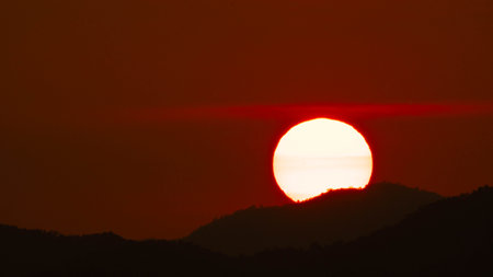 Timelapse shot of a beautiful sunrise over the horizon with an orange winter sky. Close-up of the sunrise. Morning dawn landscape.の写真素材