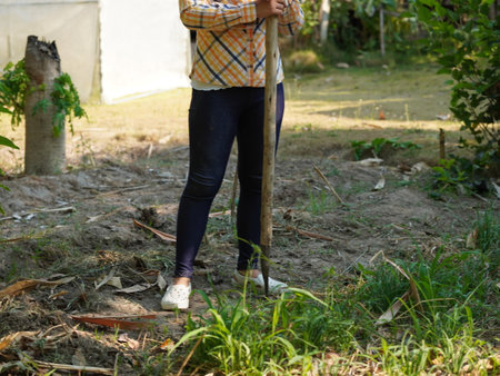 Asian adult woman working outdoors in summer garden.の写真素材