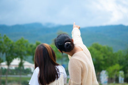 Mother and daughter spending time together in a park during spring.の写真素材