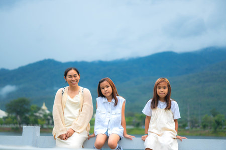 Happy mother and daughter spending time together in a park during spring.の写真素材