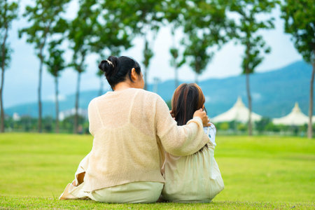 Happy mother and daughter spending time together in a park during spring.の写真素材