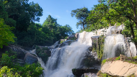 The nature of the waterfall in the forest that flows strongly during the rainy season. Strong current in the river, waters turned muddy after heavy rains in autumn.の写真素材