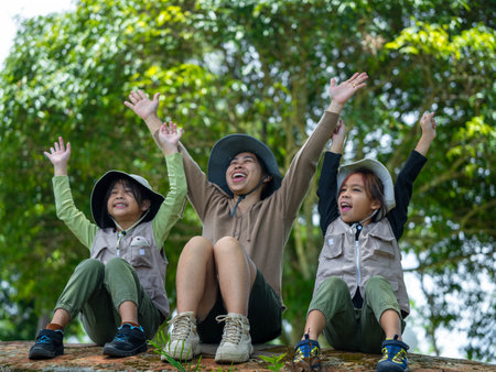 Asian mother takes her children to learn about nature in the forest to explore nature from the real...