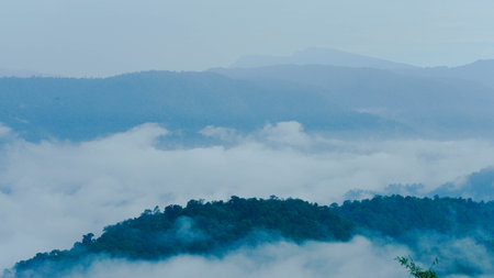 Aerial view of fog flowing over a mountain landscape in northern Thailand. Aerial view of beautiful mountains and clouds with fog.の写真素材