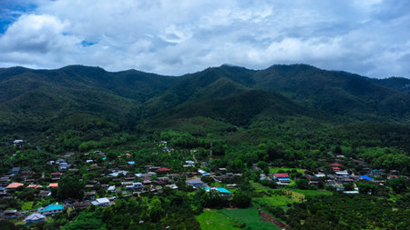 Rainy season landscape of a mountain village in the morning and mountains in the background.