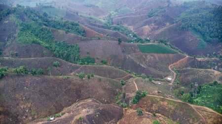 Aerial view of a mountain that has been cut down and destroyed by humans. Bird's-eye view of deforestation in Thailand. Environmental destruction.の写真素材