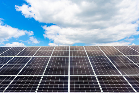 Solar panels horizontal shot on blue sky background. Ecological energy from a solar farm