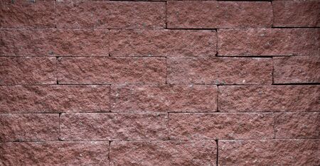 Fragment of a terracotta decorative brick wall. Thin seams, masonry sample.