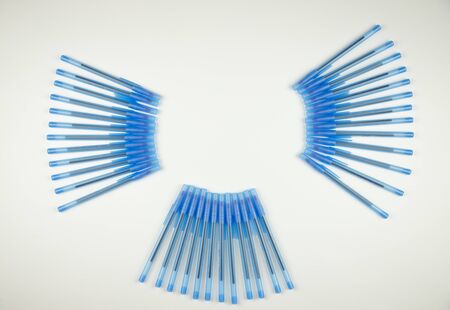 many pens for writing on a white background top view, blue color