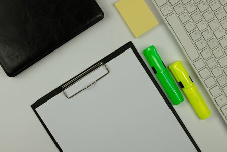 Cluttered office desk background-computer keyboard, markers, diary, note paper