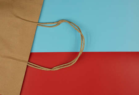 paper bag from waste paper on a red-blue background, stock photo, fluoride recycling of resources