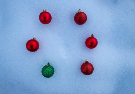toys for the new year holidays lie in the snow, red and green balls,top viewの写真素材