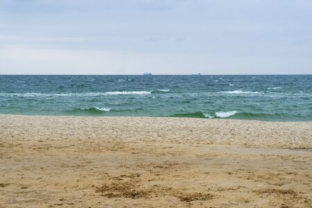 Seashore with the couple of ships on the background