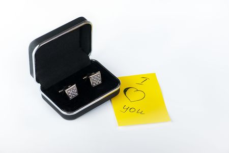 photo gift is a pair of cufflinks in a black box with a note の写真素材