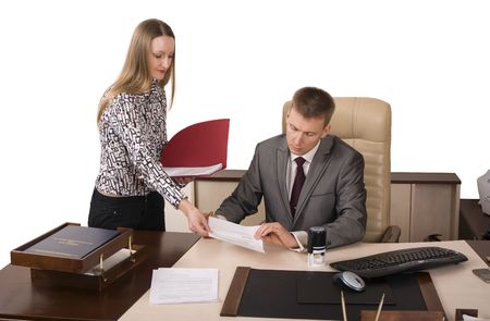 Secretary is giving documents for signing to her boss の写真素材