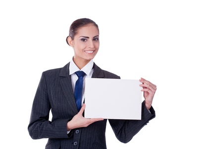 Young businesswoman pointing into empty blank and smilingの写真素材