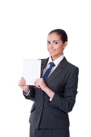 Young businesswoman pointing into empty blank and smilingの写真素材